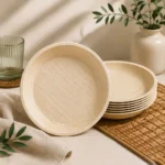 Round natural-tone plates with a gently raised rim and a visible leaf-grain surface.