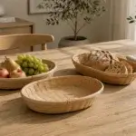 Shallow oval baskets with a fine woven base and a bound rim, shown in a coordinated tabletop arrangement.