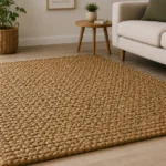 A rectangular jute rug with a pronounced chunky woven texture and a warm natural tone.