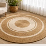 A round jute rug with contrasting pale rings arranged in a concentric pattern.