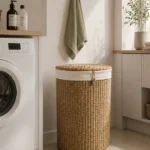 A tall round woven laundry hamper with a fabric liner folded over the rim and a fitted lid.