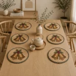 Round natural-tone placemats with a festive bell motif and a contrasting dark border.